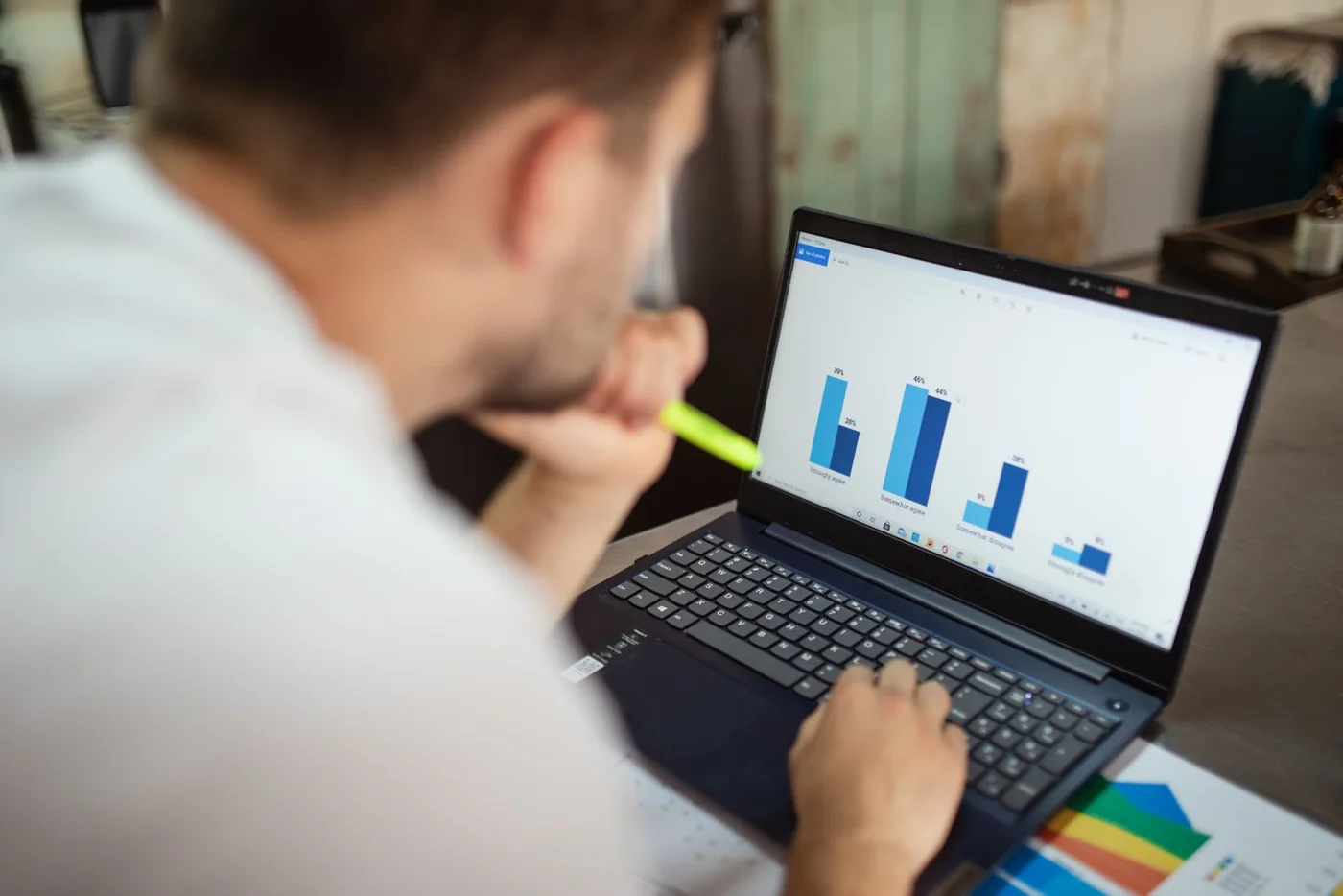 A man reviewing performance charts on a laptop.